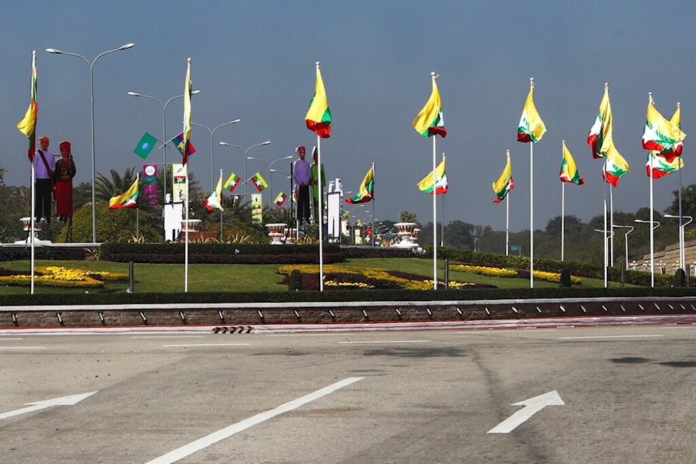 National flags line the a traffic circle ahead of Saturday's 75th Union Day, Friday, Feb. 11. 2022, in Naypyitaw, Myanmar. (AP Photo)