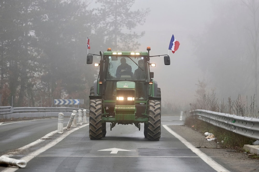 A farmer drives his tractor on a highway, near Agen, southwestern France, Saturday, Jan. 27, 2024. (AP)