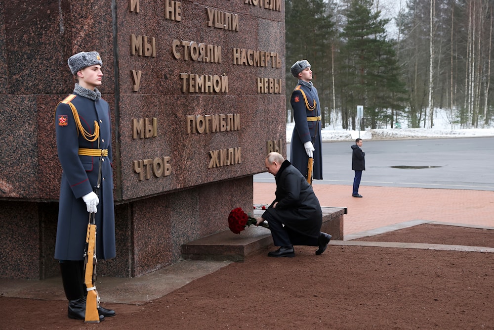 Russian President Vladimir Putin places flowers on a monument at Nevsky Pyatachok near Kirovsk, Russia, January 27, 2024 (AP)