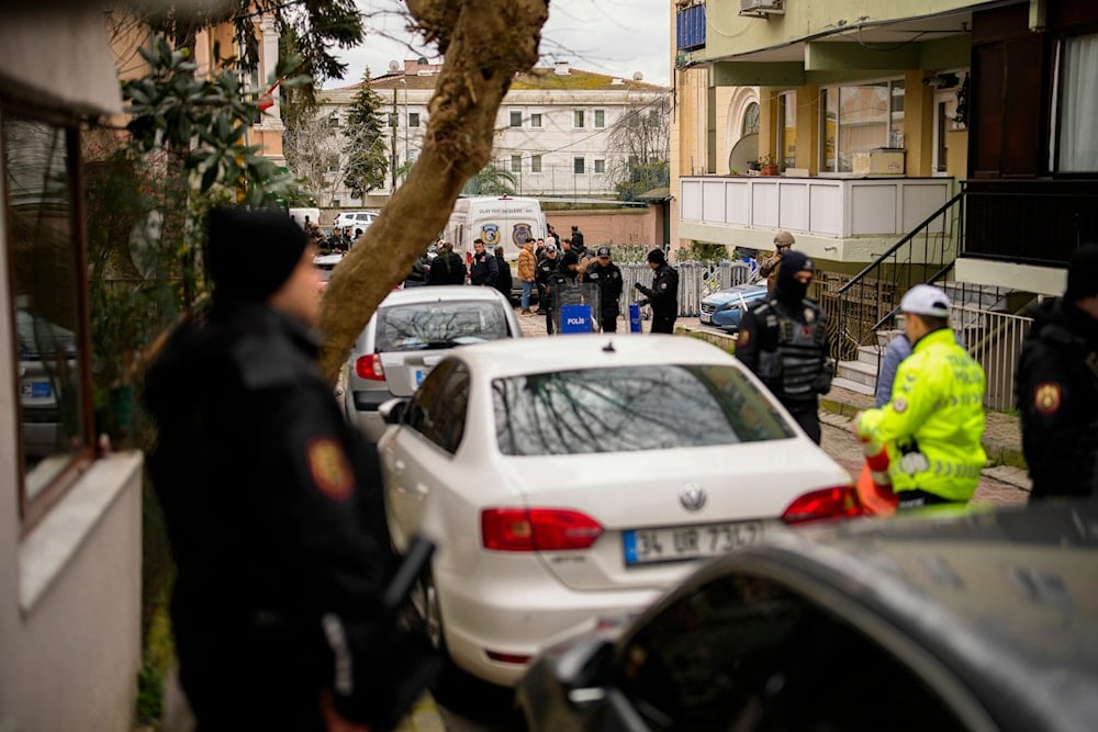 Turkish police officers stand guard on a cordoned-off area outside Santa Maria church in Istanbul, Turkey, January 28, 2024, after an attack (AP)