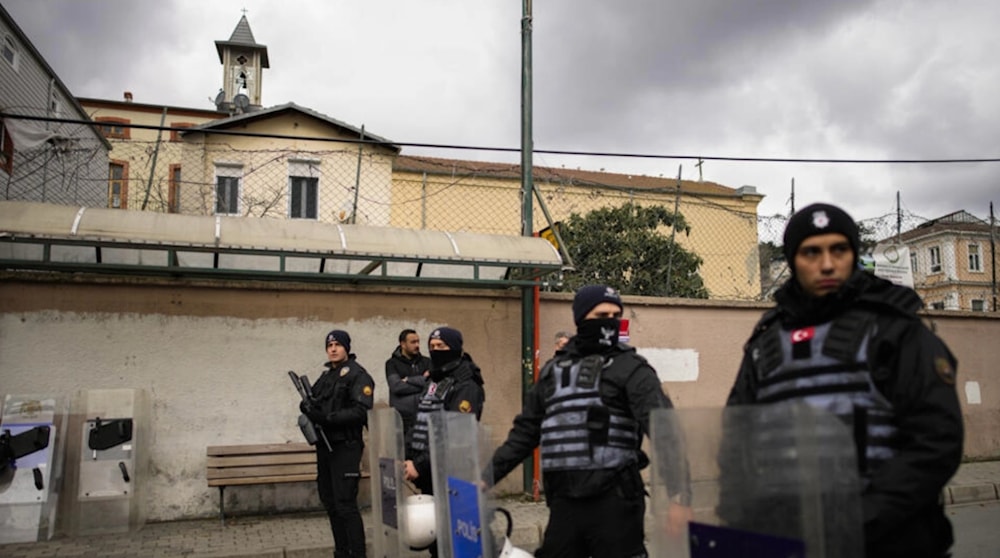 Turkish police officers stand guard in a cordoned off area outside the Santa Maria church, in Istanbul, Turkey on January 28, 2024. (AP)
