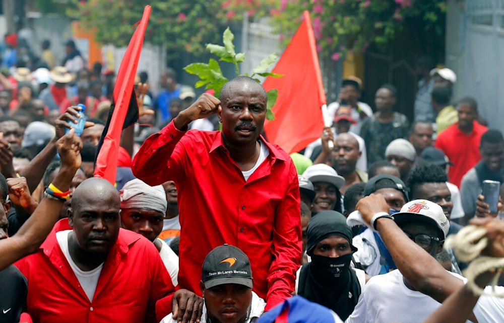 Former presidential candidate Moise Jean Charles chants anti-government slogans during a protest demanding the resignation of President Jovenel Moise in Port-au-Prince, Haiti, Sunday, June 9, 2019 (AP)