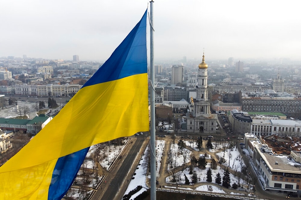 A Ukrainian national flag waves over the center of Kharkiv, Ukraine's second-largest city, Wednesday, Feb. 16, 2022. (AP)