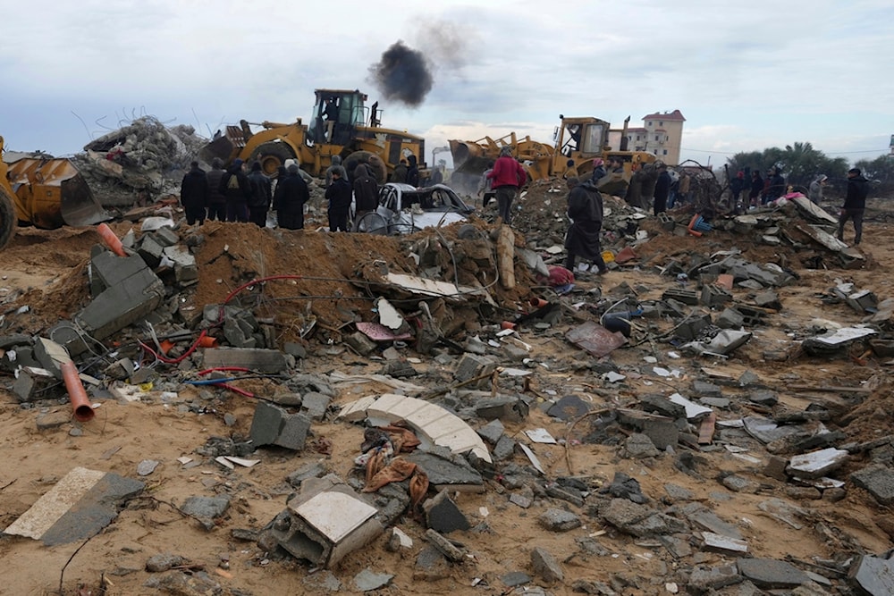 Palestinians search for the bodies after an Israeli strike in Zuweida, Gaza Strip, Monday, Jan. 29, 2024 (AP Photo/Adel Hana)