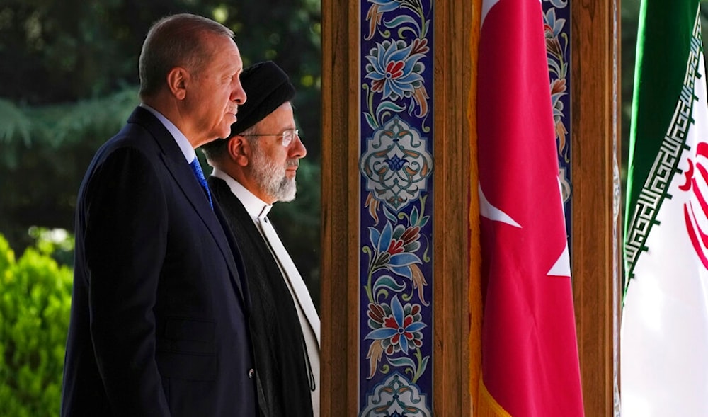 Turkish President Recep Tayyip Erdogan, and his Iranian counterpart Ebrahim Raisi listen to their countries' national anthem, in Tehran, Iran, Tuesday, July 19, 2022. (AP)