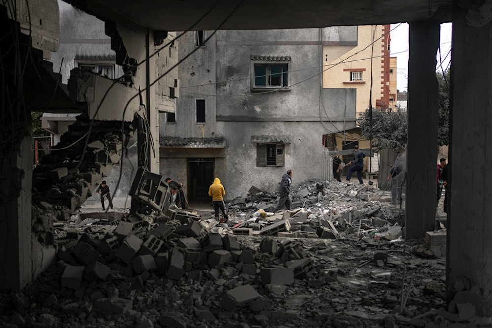 Palestinians look at the destruction after an Israeli strike in Rafah, southern Gaza Strip, Wednesday, Jan. 3, 2024 (AP)