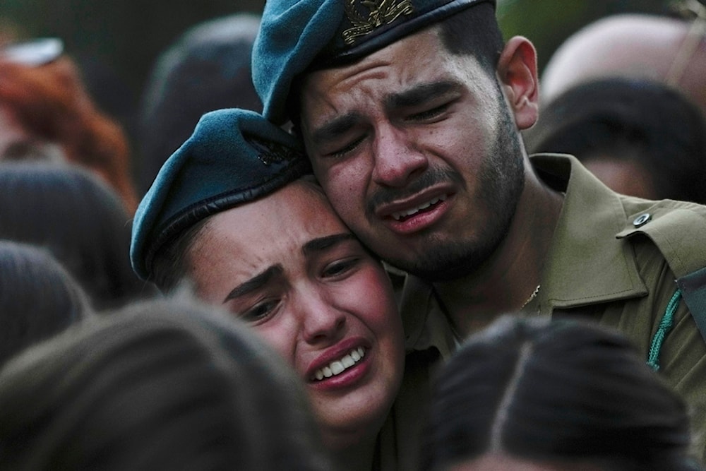 Israeli soldiers cry during the funeral of Sgt. Yam Goldstein, 