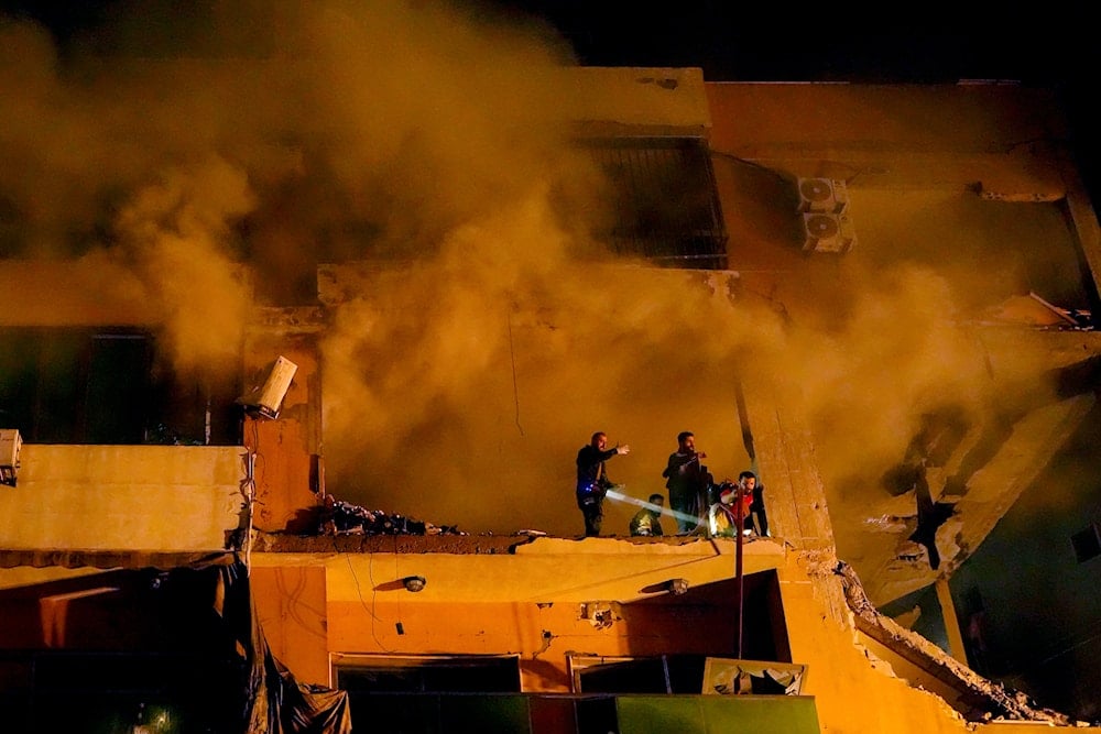 Smoke rises from a destroyed apartment as civil defense workers search for survivors following a massive explosion in the southern Beirut suburb of Dahiyeh, Lebanon, January 2, 2024 (AP)