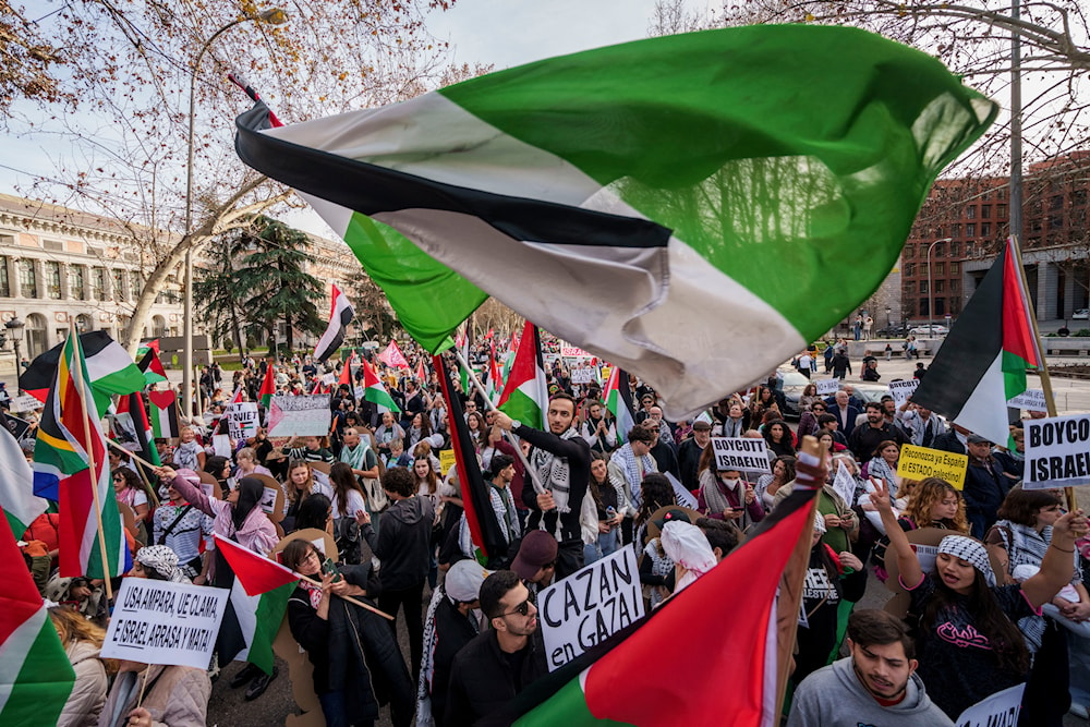 People march during a protest in support of Palestinians and calling for an immediate ceasefire in Gaza in downtown Madrid, Spain, January 27, 2024 (AP)