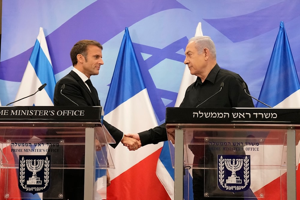 Israeli Prime Minister Benjamin Netanyahu, right, shakes hands with French President Emmanuel Macron October 24, 2024 (AP)