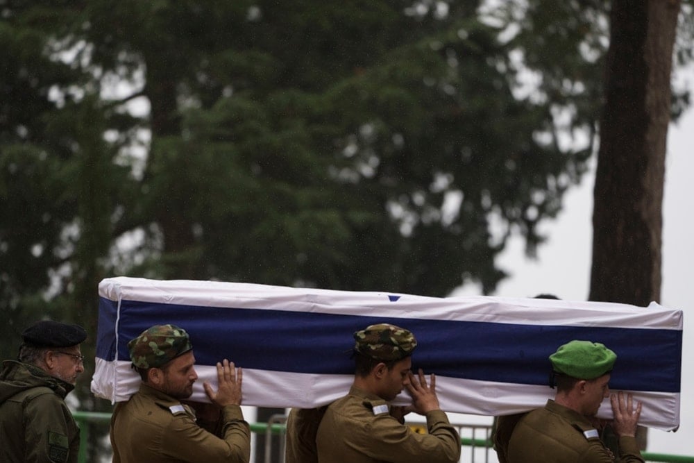 Israeli occupation soldiers carry a casket of a reservist during his funeral in occupied al-Quds, Wednesday January 24, 2024. (AP)