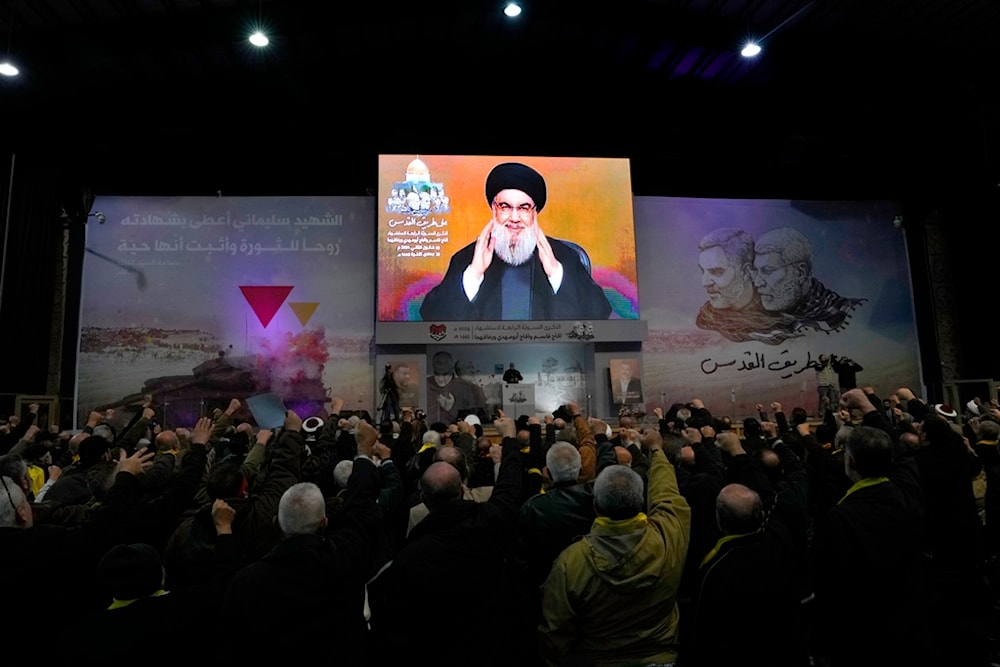 Hezbollah leader Sayyed Hassan Nasrallah greets his supporters via a video link in the southern suburbs of Beirut, Lebanon, Wednesday, Jan. 3, 2024. (AP)