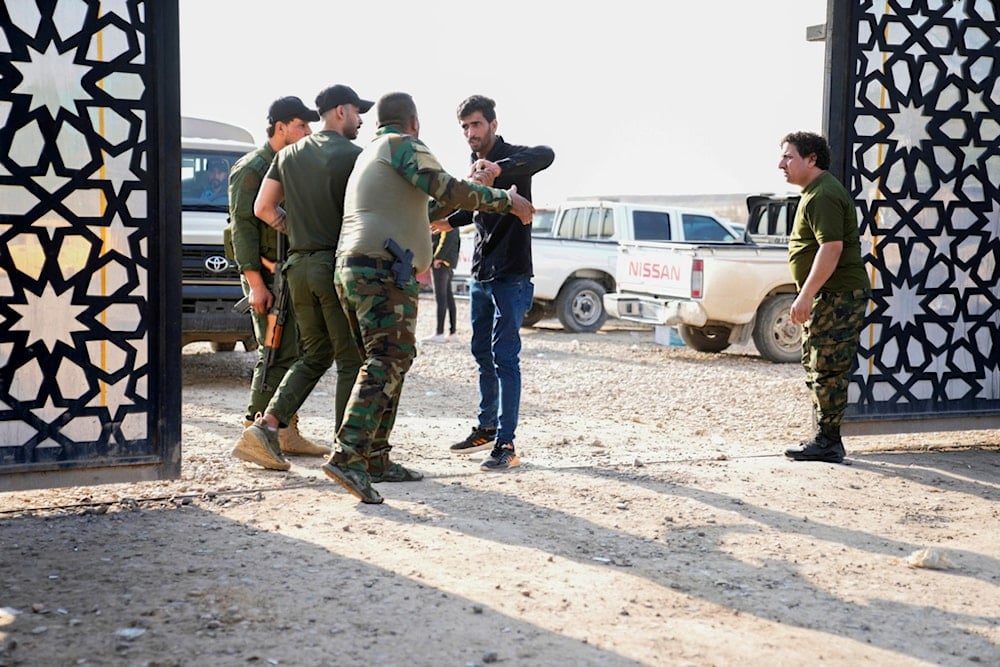 Members of the PMF stand outside the headquarters of the Popular Mobilization Force after it was hit by an airstrike in Baghdad, Iraq, Thursday, Jan. 4, 2024 (AP Photo/Hadi Mizban)