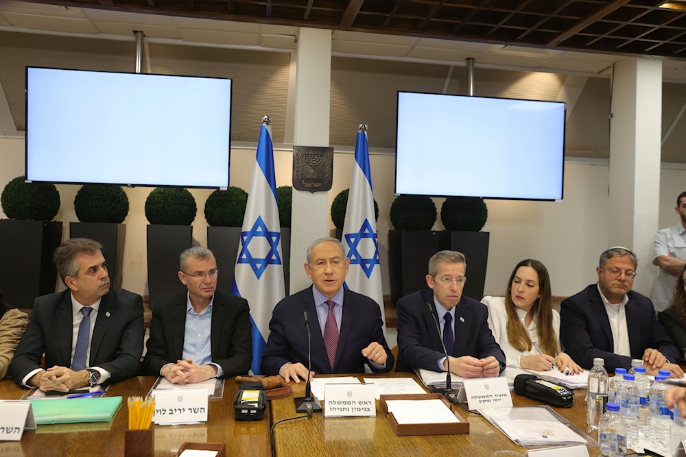 Israeli Prime Minister Benjamin Netanyahu, center, attends the weekly cabinet meeting at the 