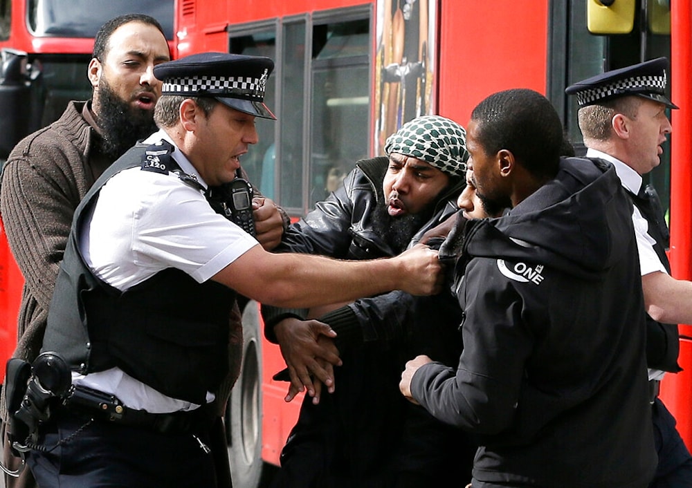 Demonstrators clash with police officers outside The Royal Courts of Justice in London Friday, Oct. 5, 2012 (AP)