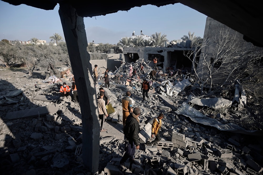 Palestinians inspect the damage of a destroyed house following Israeli airstrikes on Khan Younis, Southern Gaza Strip, Sunday, Dec. 31, 2023. (AP)