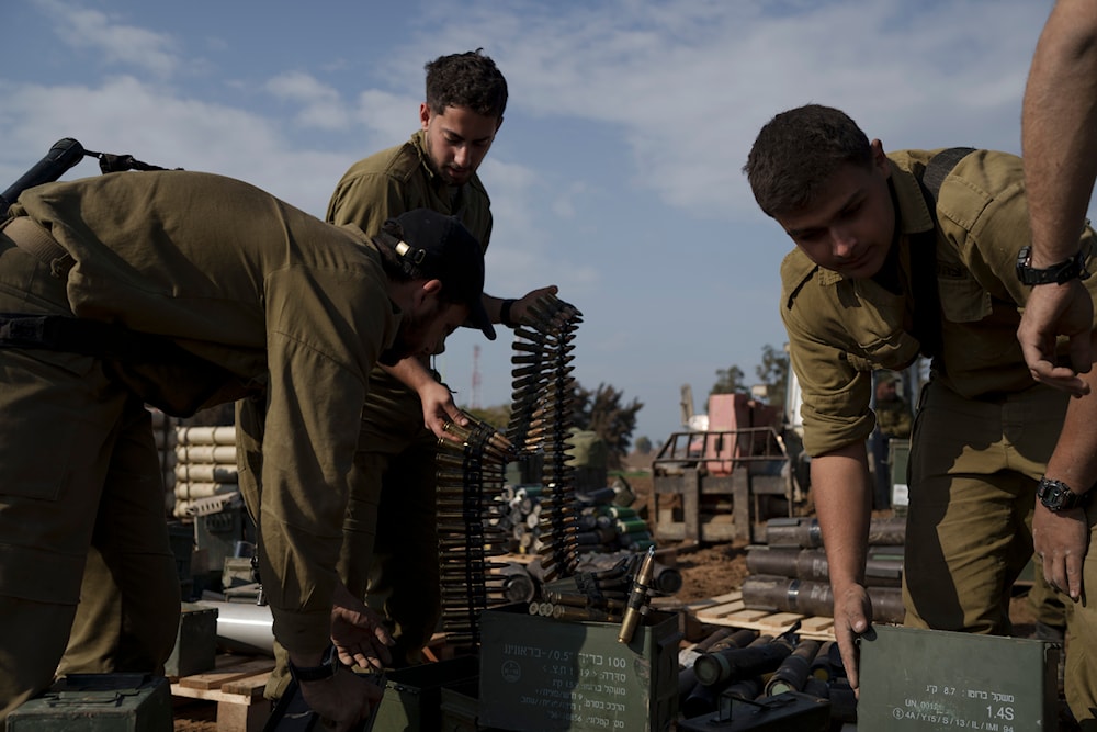 Israeli soldiers store ammunition in a staging area at the Gaza envelope in southern occupied Palestine, January 2, 2024 (AP)