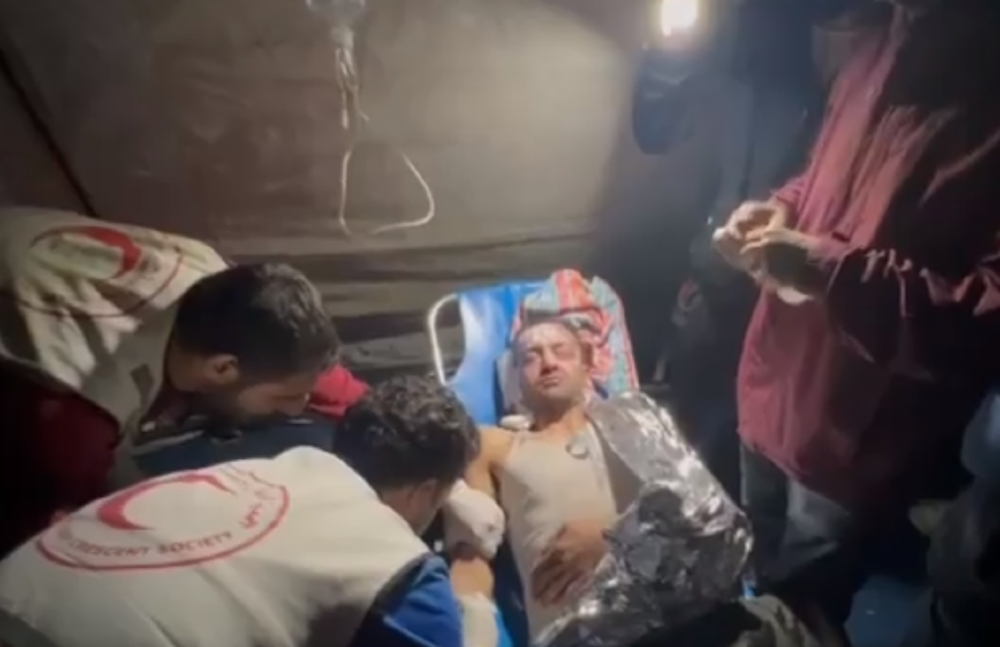 Palestine Red Crescent Society treating Palestinians in torchlight
