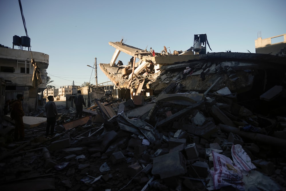 Palestinians inspect the damage of a destroyed house following Israeli airstrikes on Khan Younis, Southern Gaza Strip, Sunday, Jan. 7, 2024. (AP)