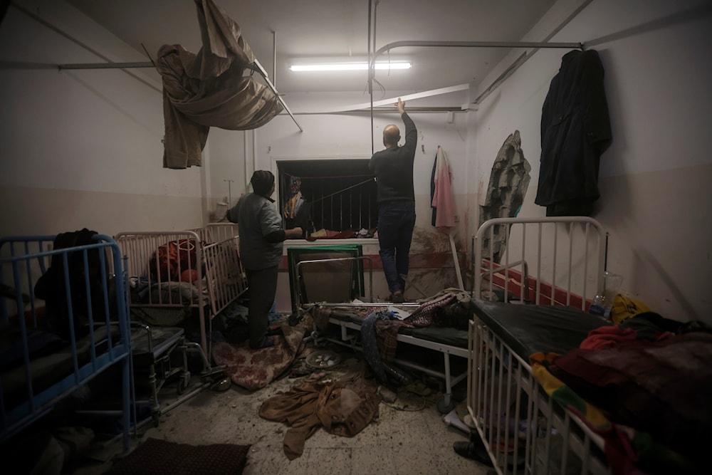 Palestinian paramedics inspect damage in the patient rooms caused by the Israeli strikes on the maternity ward at Nasser Hospital in the town of Khan Younis, southern Gaza Strip, Sunday, Dec. 17, 2023.