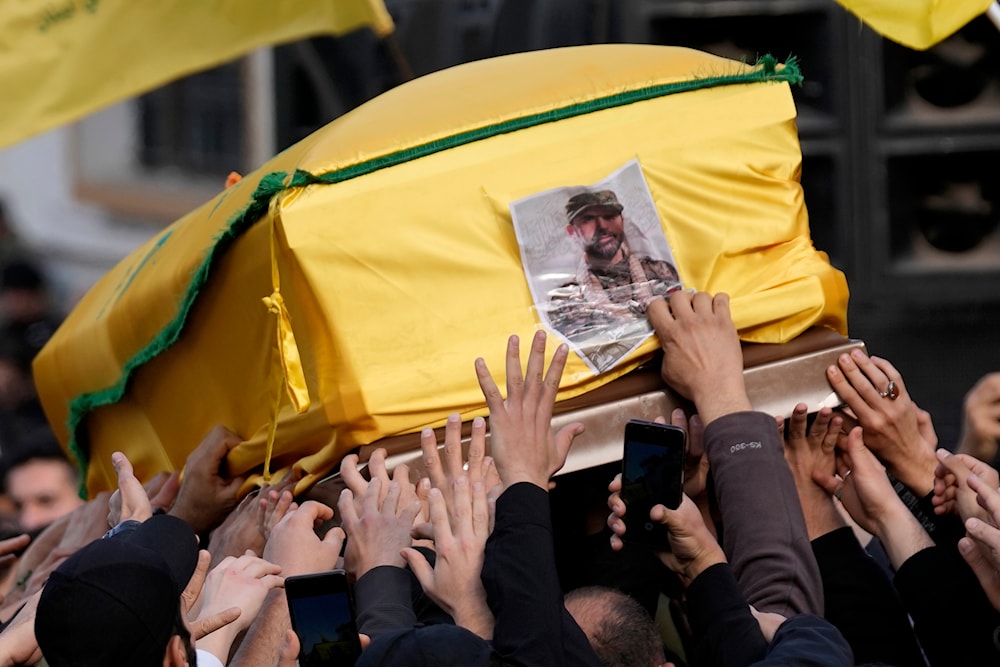 Mourners carry the coffin of senior Hezbollah commander Wissam al-Tawil during his funeral procession in the village of Khirbet Selm, south Lebanon, Tuesday, Jan. 9, 2024. 