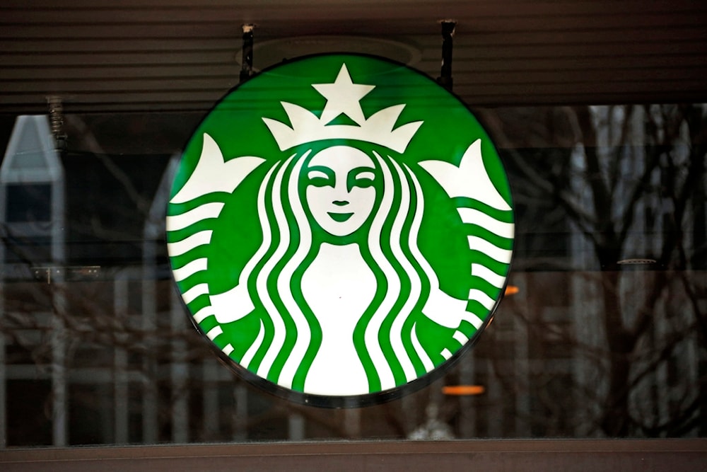 This Thursday, Jan. 12, 2017, file photo shows a Starbucks logo sign in the window of one of the chain's cafes in Pittsburgh, US. (AP)