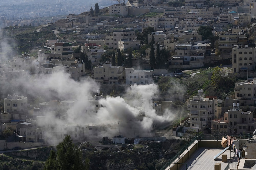 Smoke rises as Israeli security forces demolish the home of two Hamas militants in the Palestinian east al-Quds neighborhood of Sur Baher, on Tuesday, Jan. 9, 2024. (AP)