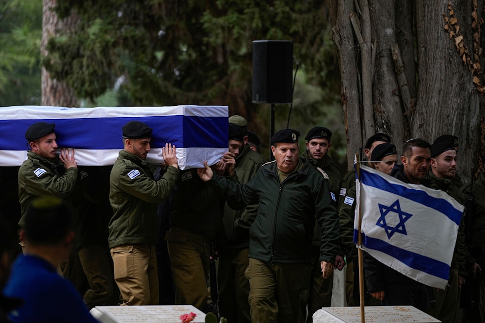 Israeli soldiers carry the flag-draped casket of reservist Hadar Kapeluk during his funeral at Mt. Herzl military cemetery in al-Quds, Tuesday, Jan. 23, 2024. (AP)