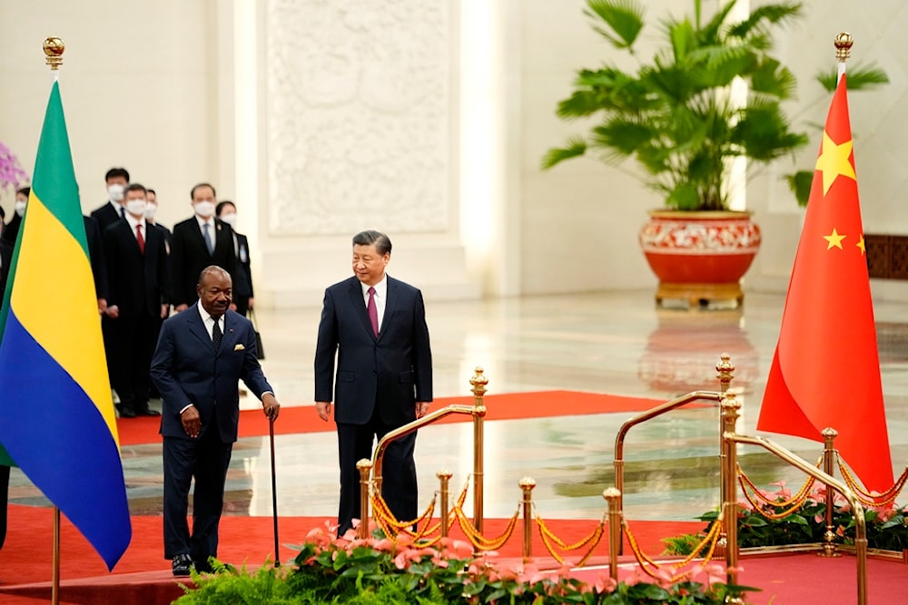 Gabonese President Ali Bongo Ondimba, left, and Chinese President Xi Jinping inspect an honor guard during a welcome ceremony at the Great Hall of the People in Beijing, Wednesday, April 19, 2023 (AP)