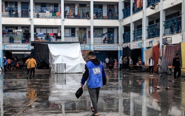 A Palestinian UNRWA Staff member aiding forcibly displaced Palestinians at a school run by UNRWA in Rafah in the southern Gaza Strip on November 14, 2023 amid Israeli genocidal war on Gaza (AFP)