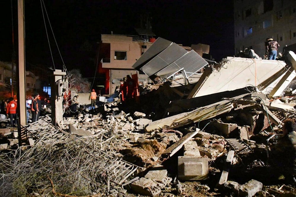 In this photo released by the Syrian official news agency SANA, Syrian security forces and civil defence workers gather next of a building that was destroyed by Israeli airstrikes, in Homs, Syria, late Tuesday, Feb. 6, 2024. (AP)