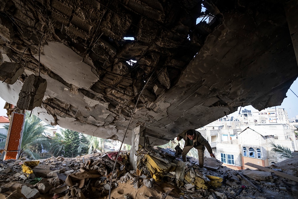 A Palestinian salvages belongings after an Israeli strike in Rafah, Gaza Strip, occupied Palestine, February 10, 2024 (AP)