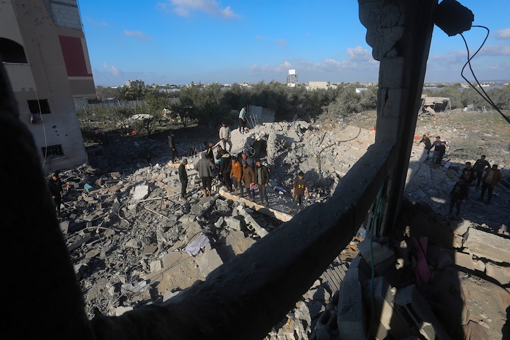 Palestinians search for survivors after an Israeli airstrike on a residential building In Rafah, Gaza Strip, occupied Palestine, February 10, 2024 (AP)