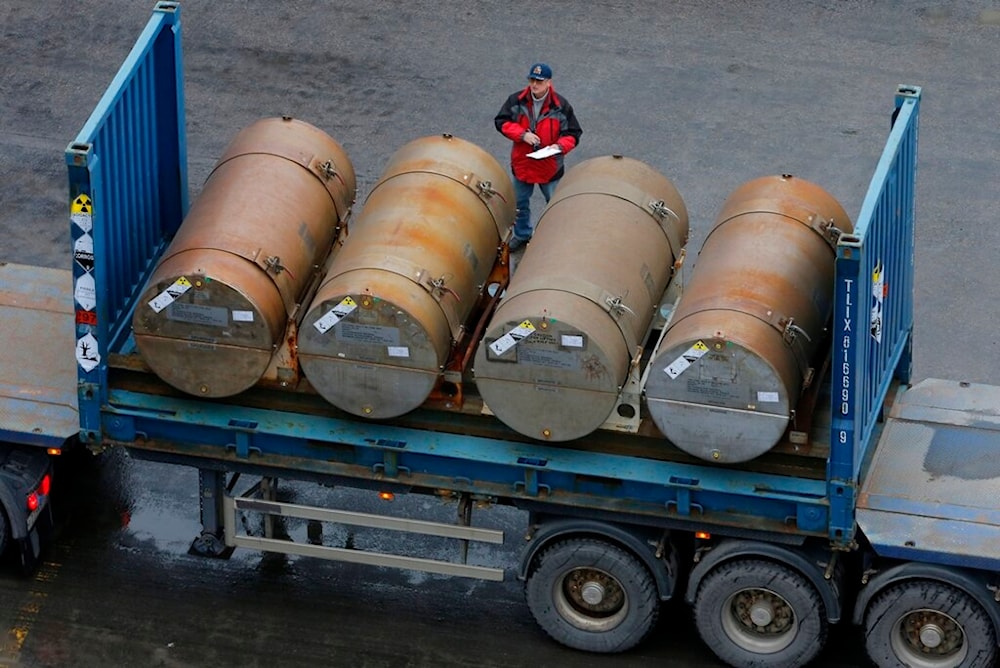 A truck carries containers with low-enriched uranium to be used as fuel for nuclear reactors, on a port in St. Petersburg, Russia, Thursday, Nov. 14, 2013. (AP)