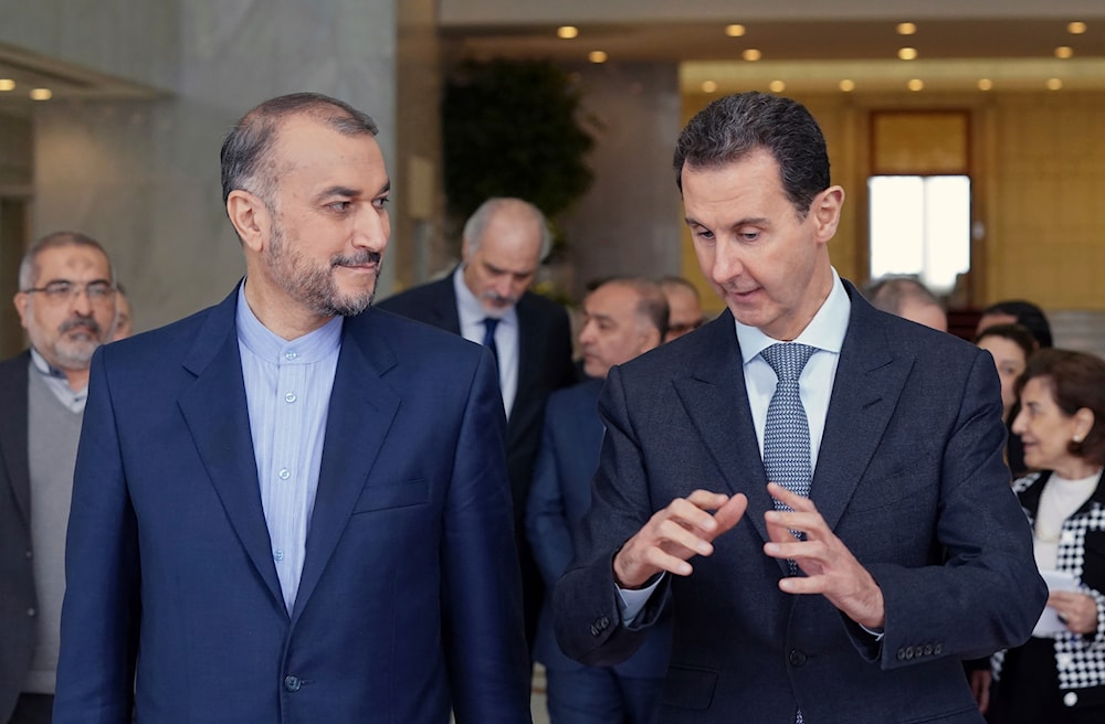 In this photo released by the Syrian official news agency SANA, Syrian President Bashar Assad, right, speaks with Iran's Foreign Minister Hossein Amir-Abdollahian, March 23, 2022, in Damascus, Syria (AP)