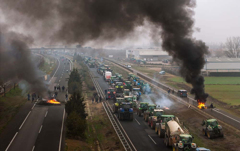 Farmers make barricades after blocking a highway during a protest near Mollerussa, northeast Spain, Tuesday, Feb. 6, 2024. (AP)
