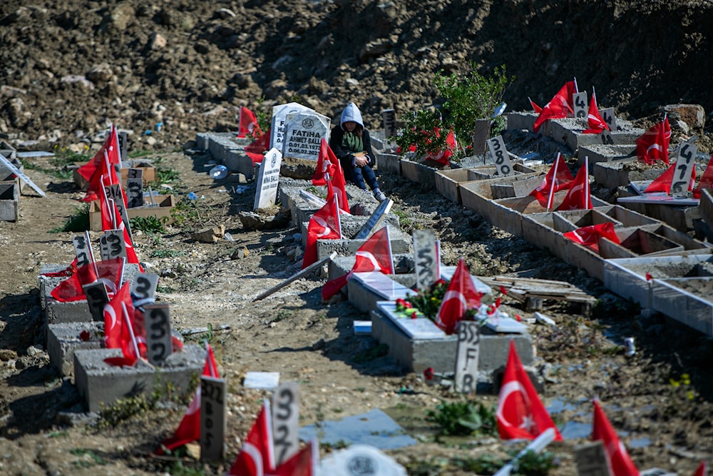 People visit graves in a cemetery where some of the victims of the powerful Feb. 6, 2023 earthquake are buried in Antakya, southern Turkey, Tuesday, Feb. 6, 2024. (AP)