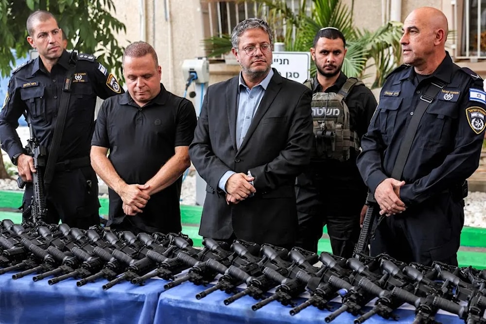 Israeli police minister, Itamar Ben-Gvir, distributing weapons to settlers in the West Bank (AFP via Getty Images)