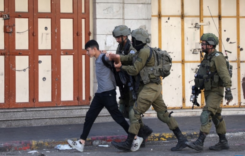 Illustrative: Israeli occupation forces detain a Palestinian youth in the city of al-Khalil in the occupied West Bank on September 29, 2022. (AFP)