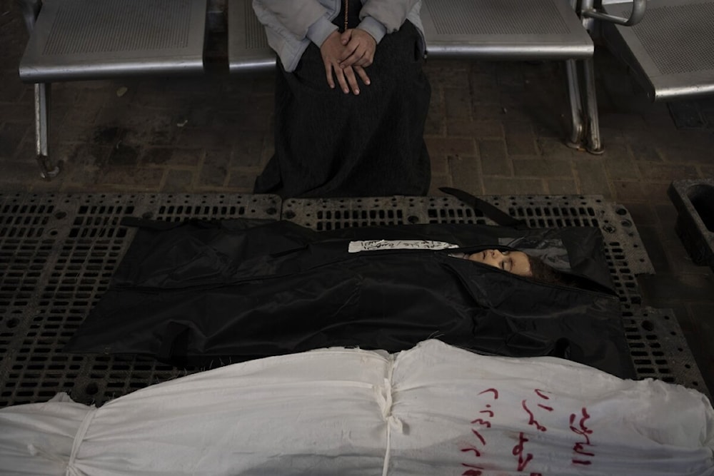 A Palestinian mother mourns next to her child's body outside a morgue in Rafah on February 4, 2024. (AP)