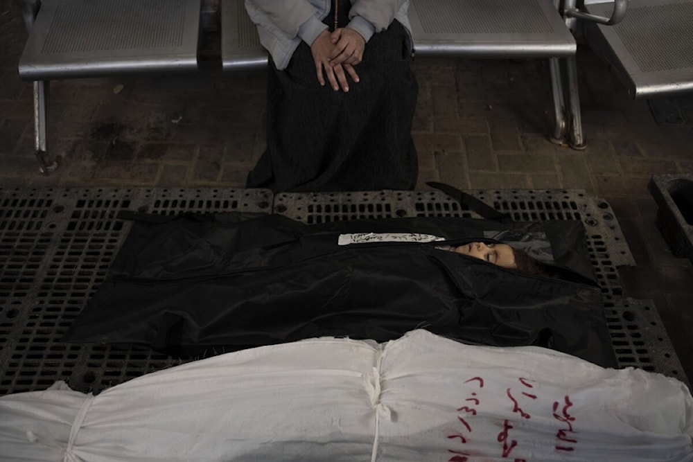 A Palestinian mother mourns next to her child's body outside a morgue in Rafah on February 4, 2024. (AP)