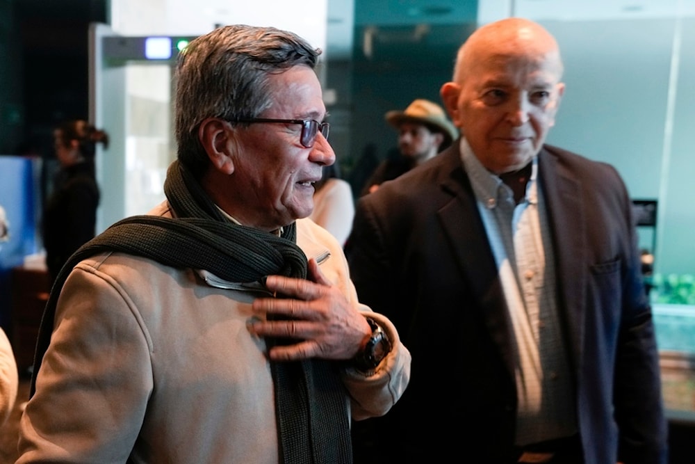 Pablo Beltran, left, commander and chief negotiator for the ELN and Jose Otty Patiño, chief negotiator for the Colombian government, arrive for a press conference as a part of peace talks in Bogota, Colombia, Tuesday, Oct. 10, 2023. (AP)