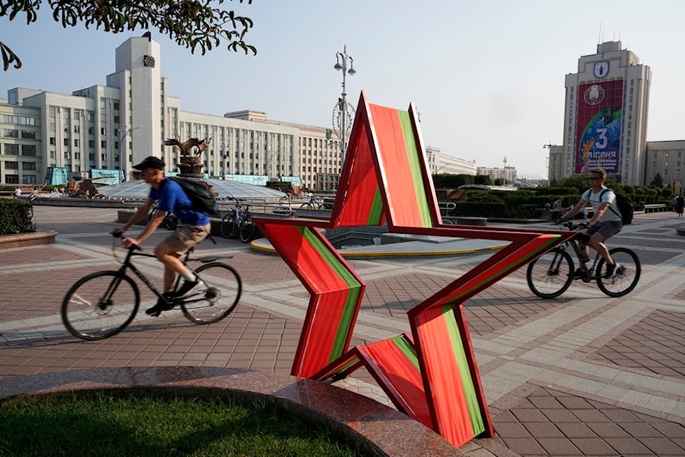 Men ride their bicycles in Independent Square during sunset in Minsk, Belarus, Wednesday, July 5, 2023. (AP Photo/Alexander Zemlianichenko)