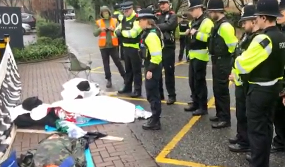 Screengrab from a video footage showing the Palestine Action activists locked together in front of Elbit Systems HQ in Bristol, England, as the police warns them to disperse on February 15, 2024. (Palestine Action)