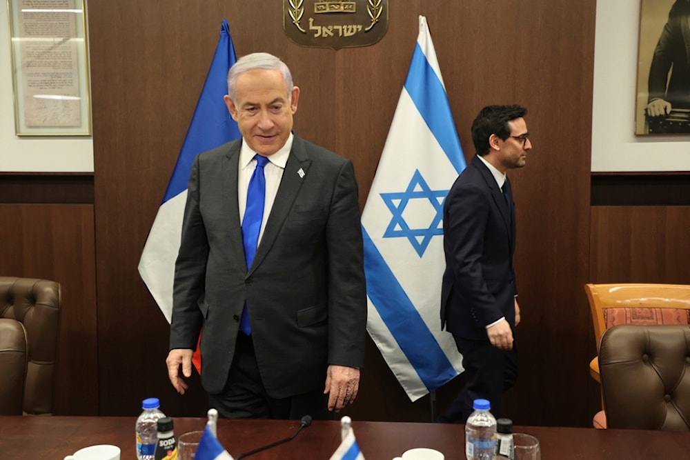 Israeli Prime Minister Benjamin Netanyahu, left, takes a seat before his meeting with France's Foreign Minister Stephane Sejourne, right, in occupied Al-Quds, Monday, Feb. 5, 2024. 5, 2024. (AP)