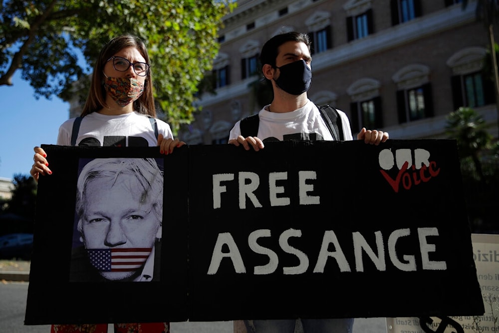 Protestors hold a placard reading Free Assange outside the United States Embassy in Rome, Monday, Sept. 7, 2020 (AP Photo/Alessandra Tarantino)