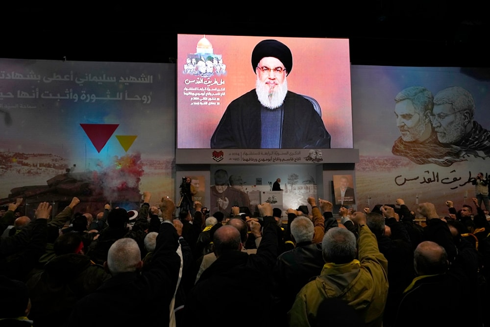 Supporters of Hezbollah raise their fists and cheer, as they listen to a speech by Hezbollah leader Sayyed Hassan Nasrallah speaking via a video link during a ceremony, Wednesday, Jan. 3, 2024. (AP)