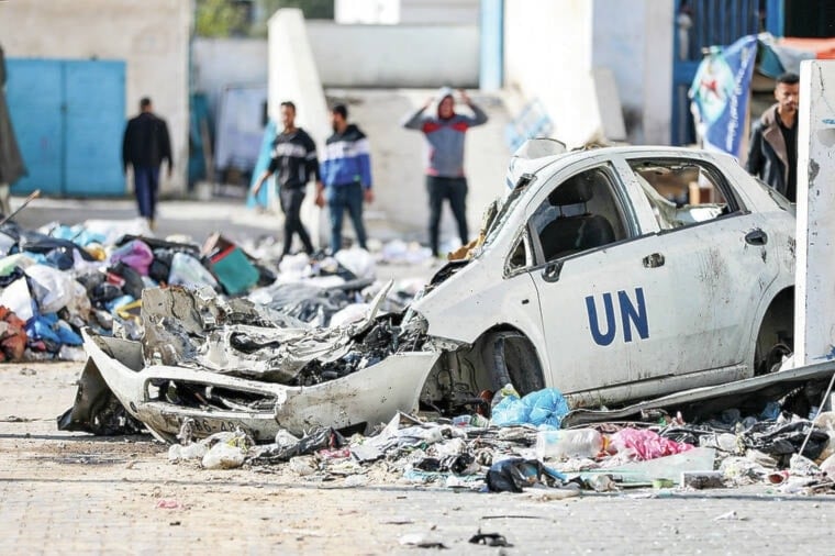  Palestinians walk through the destruction left by the Israeli air and ground offensive on the Gaza Strip in Gaza City, Saturday, Feb. 10, 2024.