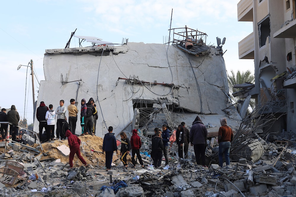 Palestinian children look at the destruction after an Israeli strike on a residential building in Rafah, Gaza Strip, Friday, Feb. 16, 2024(AP)