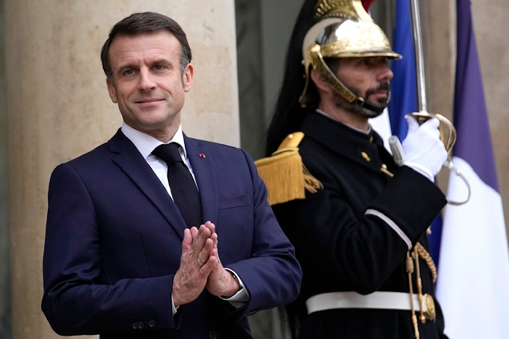 French President Emmanuel Macron gestures as he waits for Jordan's King Abdullah II prior a working lunch, Friday, Feb. 16, 2024 in Paris (AP)